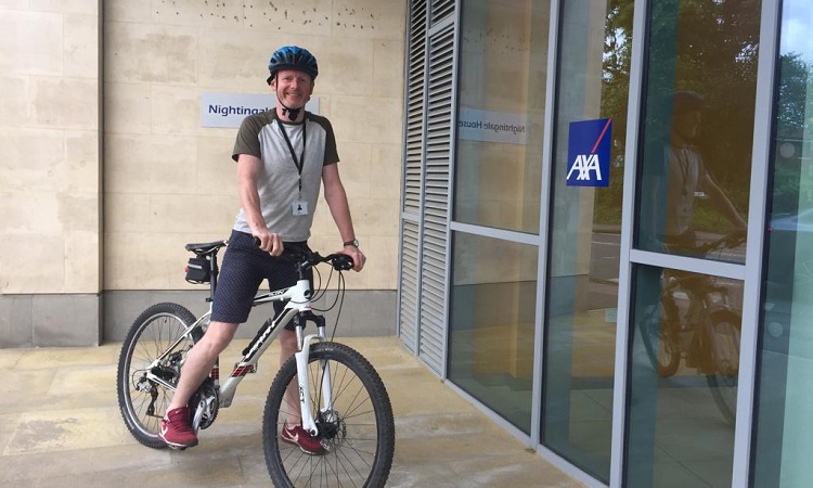 John Lyttle, Physiotherapist at AXA, on his bike outside the AXA Bristol office