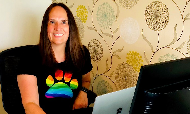 Arlene Stewart, Chair of the AXA Pride Employee Resource Group, sat at her home desk